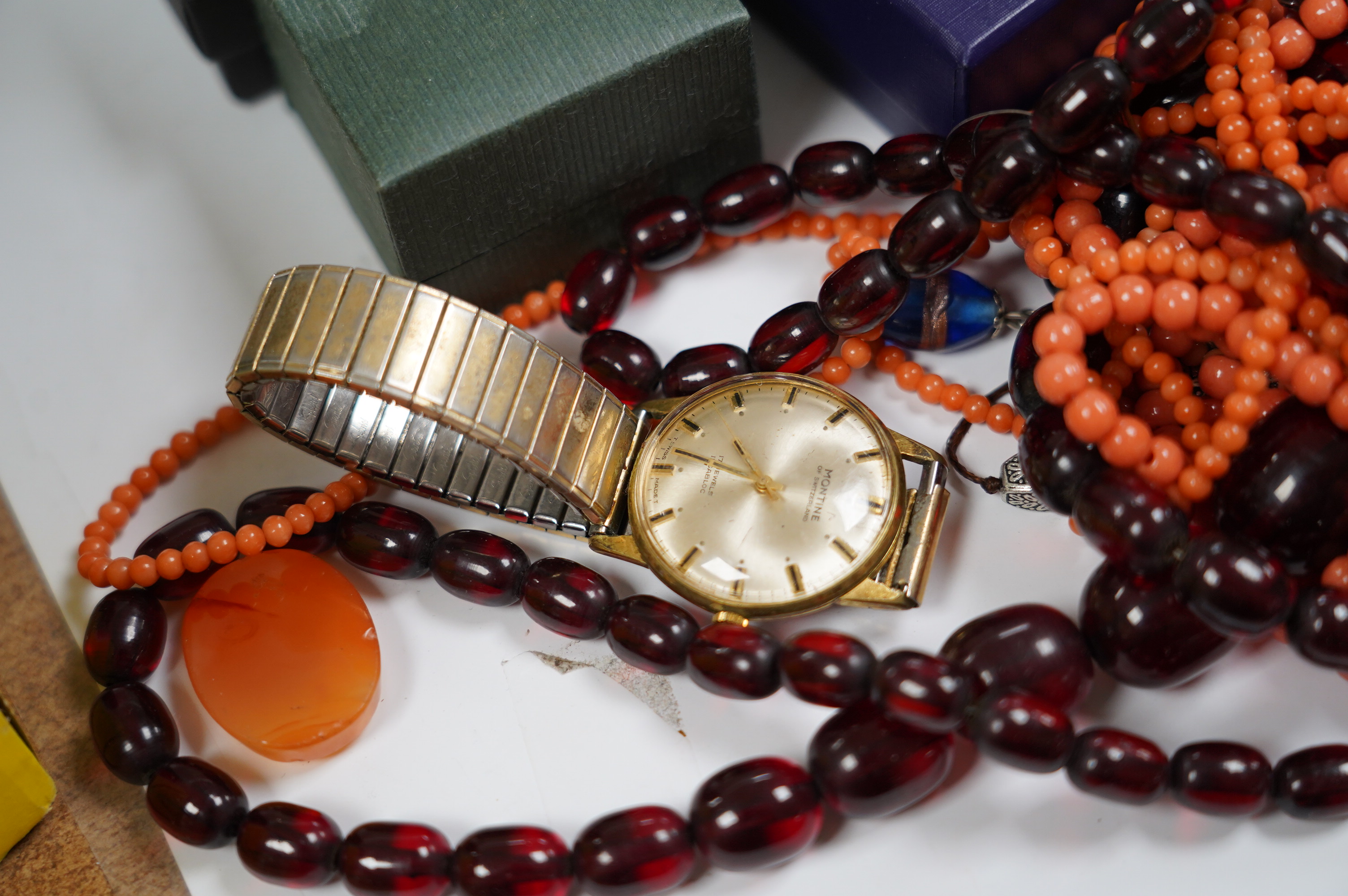 Assorted costume jewellery including simulated cherry amber necklace and simulated coral bead necklace. Condition - poor to fair